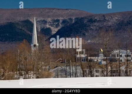 Winter view of the historic and colorful Manchester Village in Manchester, Vermont with the Taconic Mountains in the background. Stock Photo
