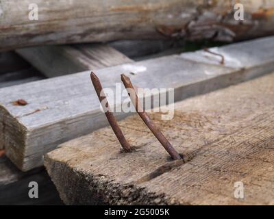 Two rusty curved nails Stock Photo