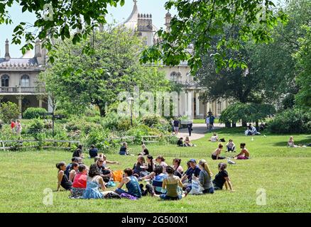 Brighton UK 24th June 2021 - Sunbathers enjoy a break in Pavilion Gardens Brighton on a beautiful warm sunny day.  : Credit Simon Dack / Alamy Live News