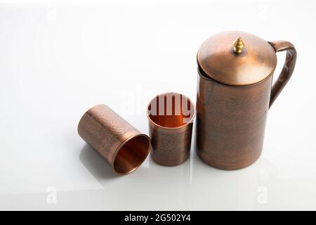 Antique Copper Jug and Tumblers on White Background Stock Photo