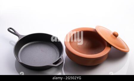 Cast Iron Skillet and Clay Pots Isolated on White Background Stock Photo