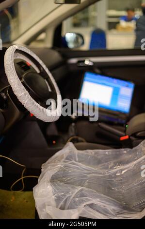 Computer diagnostics of the onboard computer in the car in a car dealership. new Stock Photo
