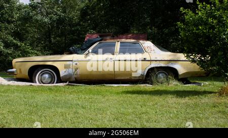 A Side View of a Weathered 1973 Oldsmobile Delta 88 Stock Photo
