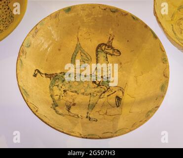 An ataifor, or deep dish, dating from the second half of the 10th century.  It is made of glazed ceramic with green and manganese decoration.  On disp Stock Photo