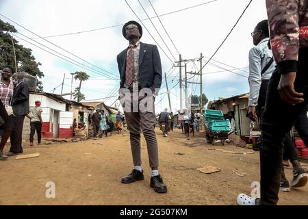 Nairobi, Kenya. 11th Dec, 2021. A young female model dressed in a colorful  outfit poses by the streets during the Mr. and Mrs. Kibera modeling contest  in Kibera Slums. Young models and