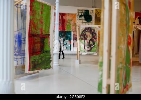 Madrid, Spain. 24th June, 2021. Several canvas hangings by artist Vivian Suter are seen during the press release of her exhibition. The Argentine artist Vivian Suter, based in Guatemala since 1982, presented her exhibition that covers her career with around 500 paintings, organized by the Museo Nacional Centro de Arte Reina Sofía, in the Palacio de Velázquez, Madrid. Her work is influenced by nature and this montage allows the viewer to walk through a forest of canvases. The exhibition will remain open until May 22, 2022. Credit: SOPA Images Limited/Alamy Live News Stock Photo