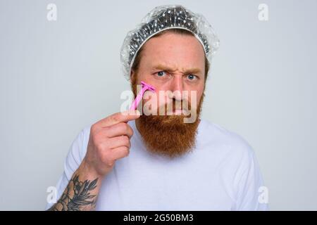 Man adjust the beard with a razor blade Stock Photo