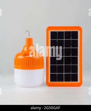Lighting bulb with solar cell panel isolated on white background Stock Photo