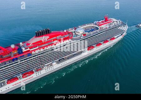 Scarlet Lady is a cruise ship operated by Virgin Voyages.  Scarlet Lady arriving at Portsmouth International Port on a sunny morning. Stock Photo