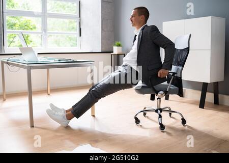 Chair Triceps Dip In Office. Workout Exercise At Desk Stock Photo