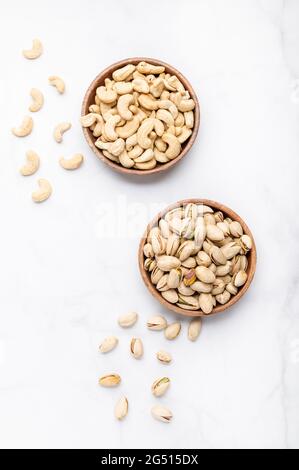 Cashew and pistachios nuts in wooden bowls Stock Photo