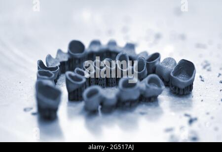 Tooth dental crowns created on 3d printer for metal Stock Photo