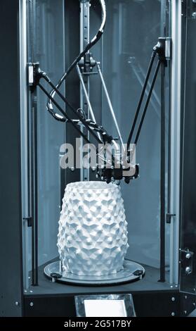 3d the printer creates a figure in the form of a white vase Stock Photo