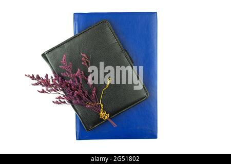 Office desktop with leather notebooks and dried flowers on it, top view, white isolated background Stock Photo