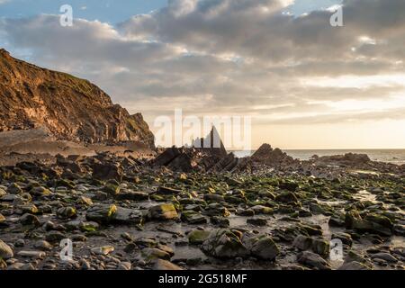 Rocks on Blackpool beach near Hartland Quay in North Devon. AONB. Stock Photo