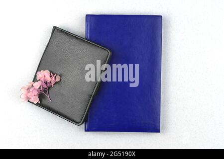 Leather notebook mockup, black and blue notepad with dried flower composition on white silver table office desktop background, flat lay and top view Stock Photo