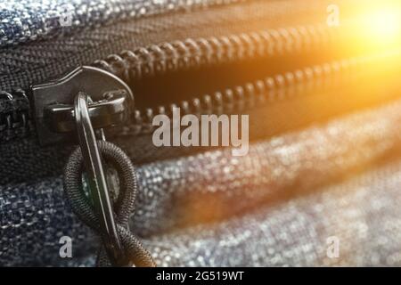 Black metal zipper is open, bag zupper close-up background Stock Photo