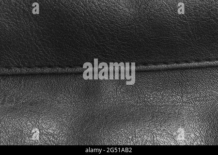 Black leather texture with the seam close-up, black bag details background Stock Photo