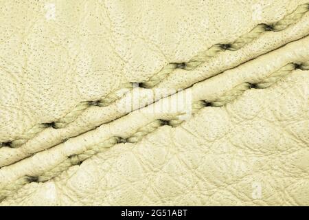 Beige leather texture and the seam close-up background, high detailed surface Stock Photo