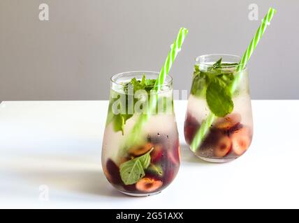 Cold drinks in small bottles. Cherries mint lemonade. Mojito coctail. Stock Photo