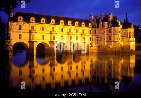 View of illuminated Chateau Chenonceau reflected in water, Indre-et Loire, Loire River Valley, France Stock Photo