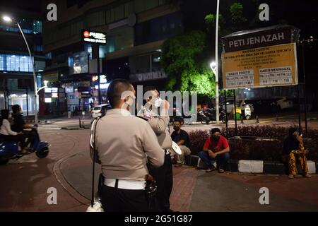 Jakarta Indonesia 24th June 21 Police Officers Through A Megaphone Urge Passers By To Take Part In Vaccinations During The Mobile Mass Covid 19 Vaccination Service The Mass Vaccination Program Initiated By