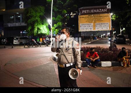 Jakarta Indonesia 24th June 21 Police Officers Through A Megaphone Urge Passers By To Take Part In Vaccinations During The Mobile Mass Covid 19 Vaccination Service The Mass Vaccination Program Initiated By