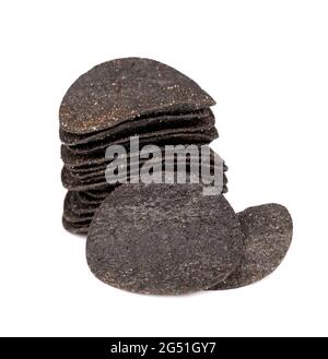 Black potato chips isolated on white background. Black chips with activated charcoal and red pepper. Stock Photo