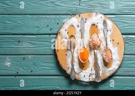 Composition with different salt and peppercorns on color wooden background Stock Photo