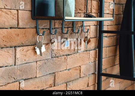 Key holder with keys hanging on the wall Stock Photo - Alamy