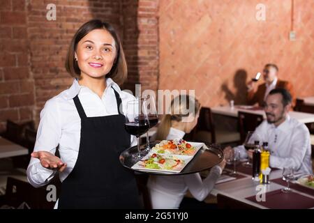 Female waiter in country restaurant Stock Photo