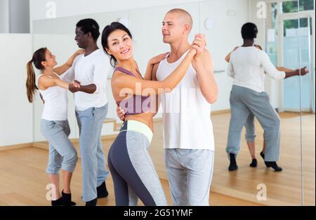 Young couples practicing active dance in pair Stock Photo
