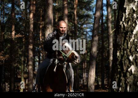 Portrait of Confident Male With Horse Standing on Field Stock Photo