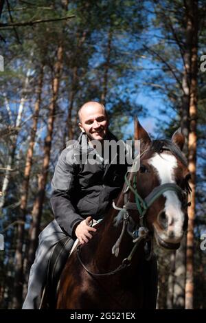 Portrait of Confident Male With Horse Standing on Field Stock Photo