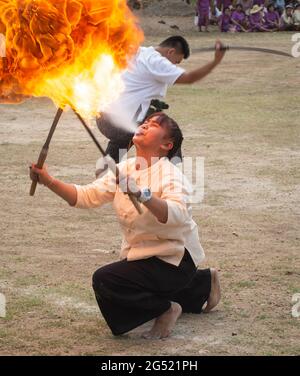 Lamphun, Thailand - April 12, 2019: Female perform fire breathing on Songkran festival in Lamphun province Stock Photo