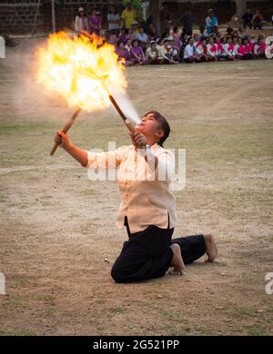 Lamphun, Thailand - April 12, 2019: Female perform fire breathing on Songkran festival in Lamphun province Stock Photo