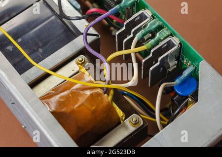 E-waste recycling concept. Old device with transformer and wires. Electronic PCB garbage from old consumer devices. Stock Photo