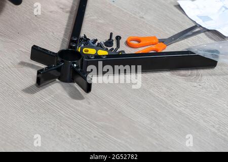 a man assembles a new chair at home. Stock Photo
