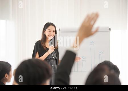 Businesswoman talking microphone present  business plan in meeting room Stock Photo