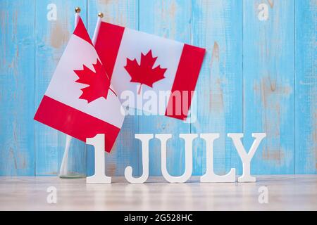 Wooden calendar of July 1st with miniature Canada flags. Canada Day  and happy celebration concepts Stock Photo