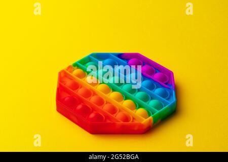 Colorful antistress pop it toy on yellow background Stock Photo