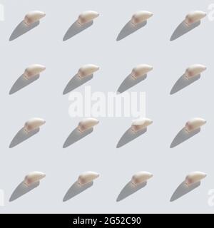 Pattern made of garlic cloves on grey background top view. Cooking blog background Stock Photo