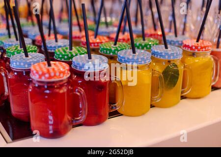 Large selection of freshest smoothies in convenient mugs cans with straws. Proper nutrition. Healthy lifestyle. Comfortable consumption of drinks. Vit Stock Photo
