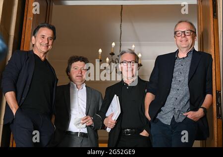 Stuttgart, Germany. 25th June, 2021. The artistic directors of the Staatstheater Stuttgart, Tamas Detrich (l-r, ballet), Stuttgart, Viktor Schoner (opera), Marc- Oliver Hendriks (managing artistic director) and Burkhard C. Kosminski (drama) and stand in an entrance to the theatre during a photo session. During a press conference, they present their plans for the next season. Credit: Bernd Weissbrod/dpa/Alamy Live News Stock Photo