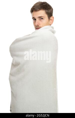 Young handsome tall slim white man with brown hair looks confident with blanket isolated on white background Stock Photo