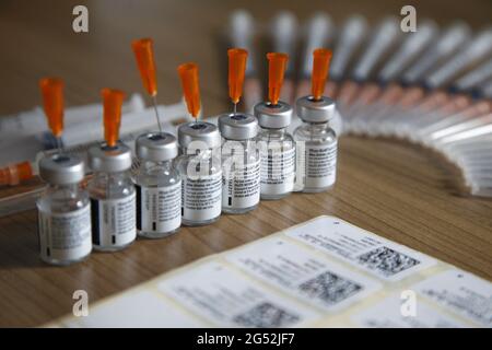 Istanbul,Turkey - 06-21-2017:View of used Biontech Pfizer covid-19 vaccine vials and syringes on table Stock Photo