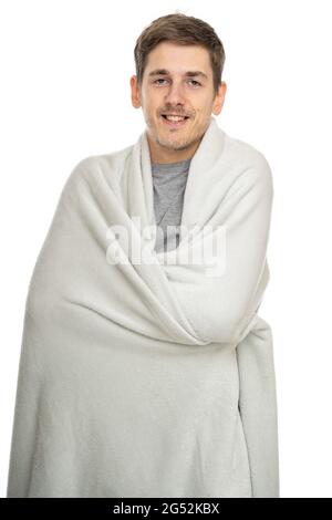 Young handsome tall slim white man with brown hair smiling with blanket isolated on white background Stock Photo