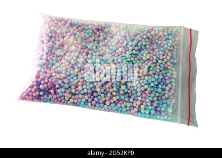 color foam balls, filler for gift box in transparent bag with zip lock. isolated on white background Stock Photo