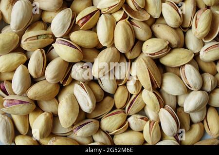 Pile of pistachios in the peel close up. Pistachios healthy omega