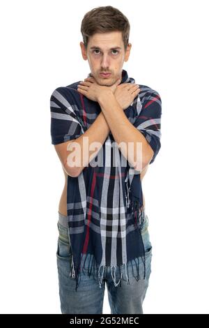 Young handsome tall slim white man with brown hair choking himself with scarf over his body in blue jeans isolated on white background Stock Photo